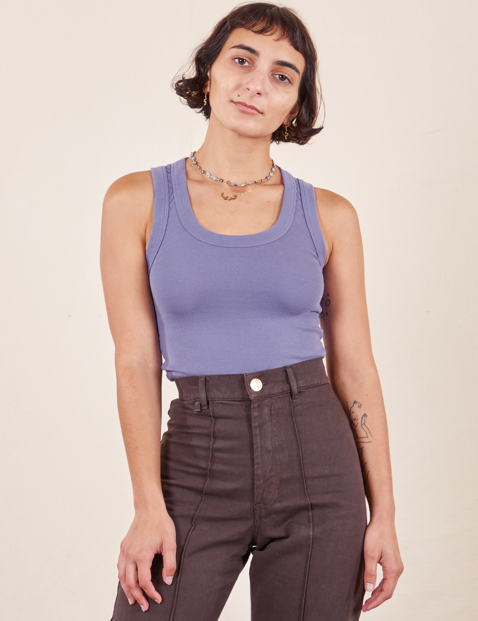 Soraya is wearing P Tank Top in Faded Grape paired with espresso brown Western Pants
