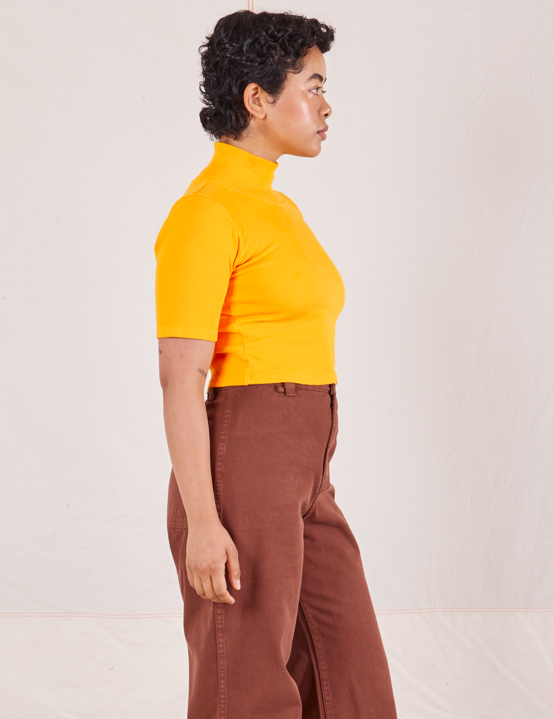 1/2 Sleeve Essential Turtleneck in Sunshine Yellow side view on Mika wearing fudgesicle brown Bell Bottoms