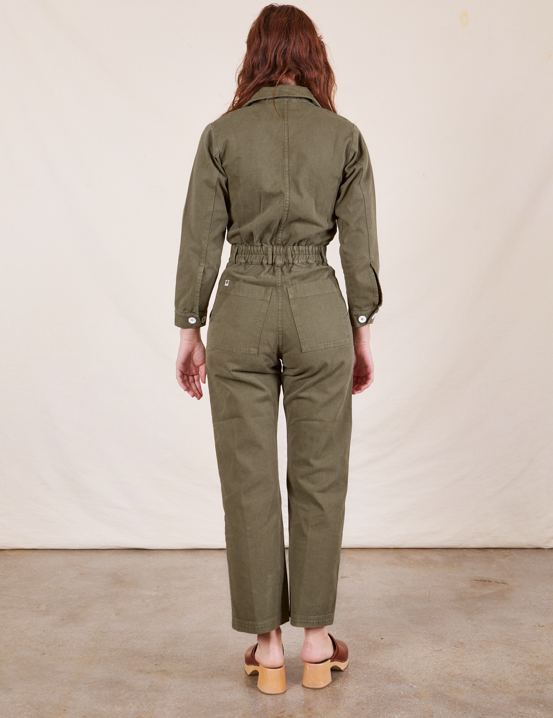 Back view of Everyday Jumpsuit in Surplus Green worn by Alex