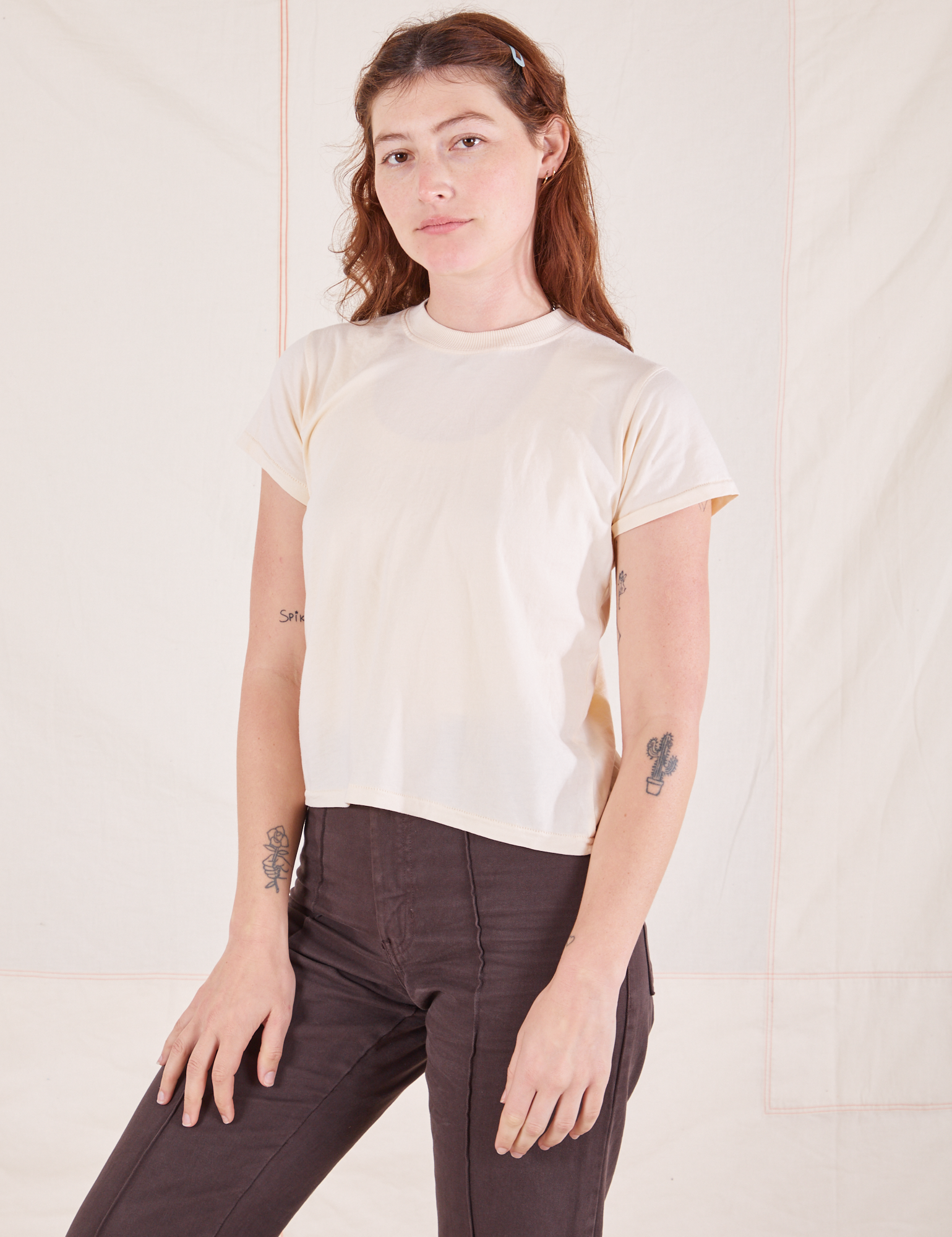 Alex is wearing Organic Vintage Tee in Sunshine Yellow and espresso brown Western Pants