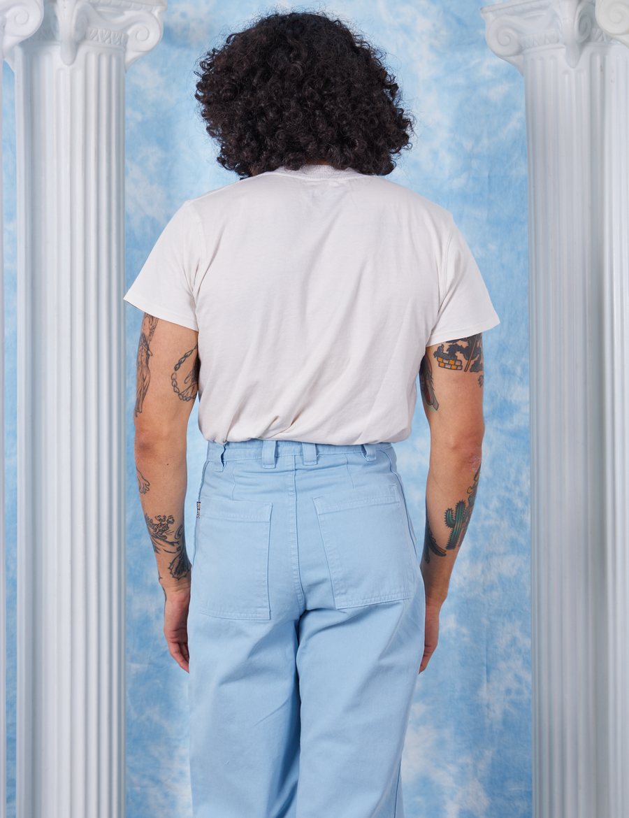 Peach Airbrush Organic Tee back view on Jesse wearing baby blue Bell Bottoms