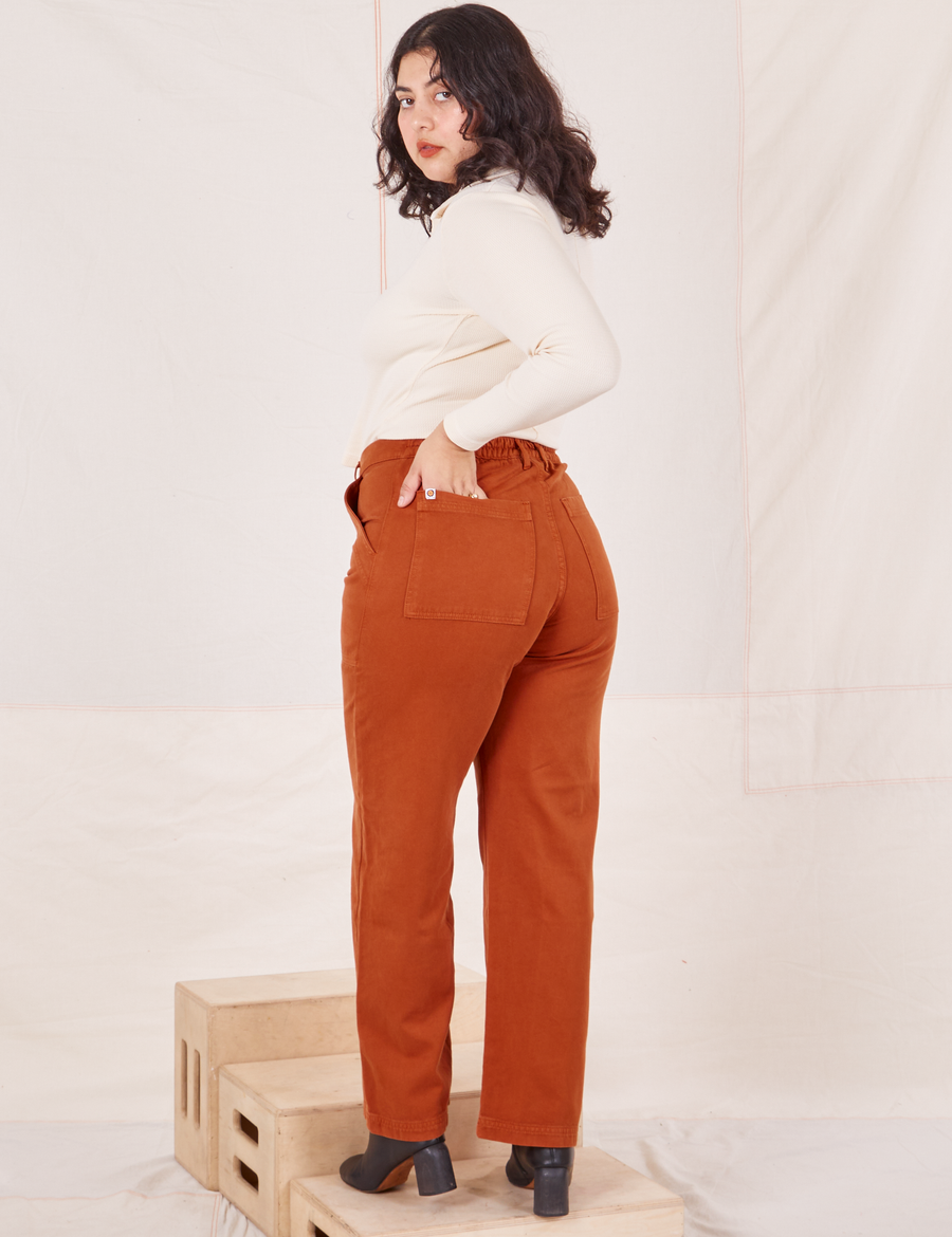 Organic Work Pants in Burnt Terracotta back view on Melanie wearing vintage off-white Long Sleeve Fisherman Polo