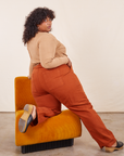 Angled back view of Work Pants in Burnt Terracotta and tan Wrap Top on Morgan