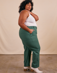 Side view of Work Pants in Dark Emerald Green and vintage off-white Tank Top on Morgan