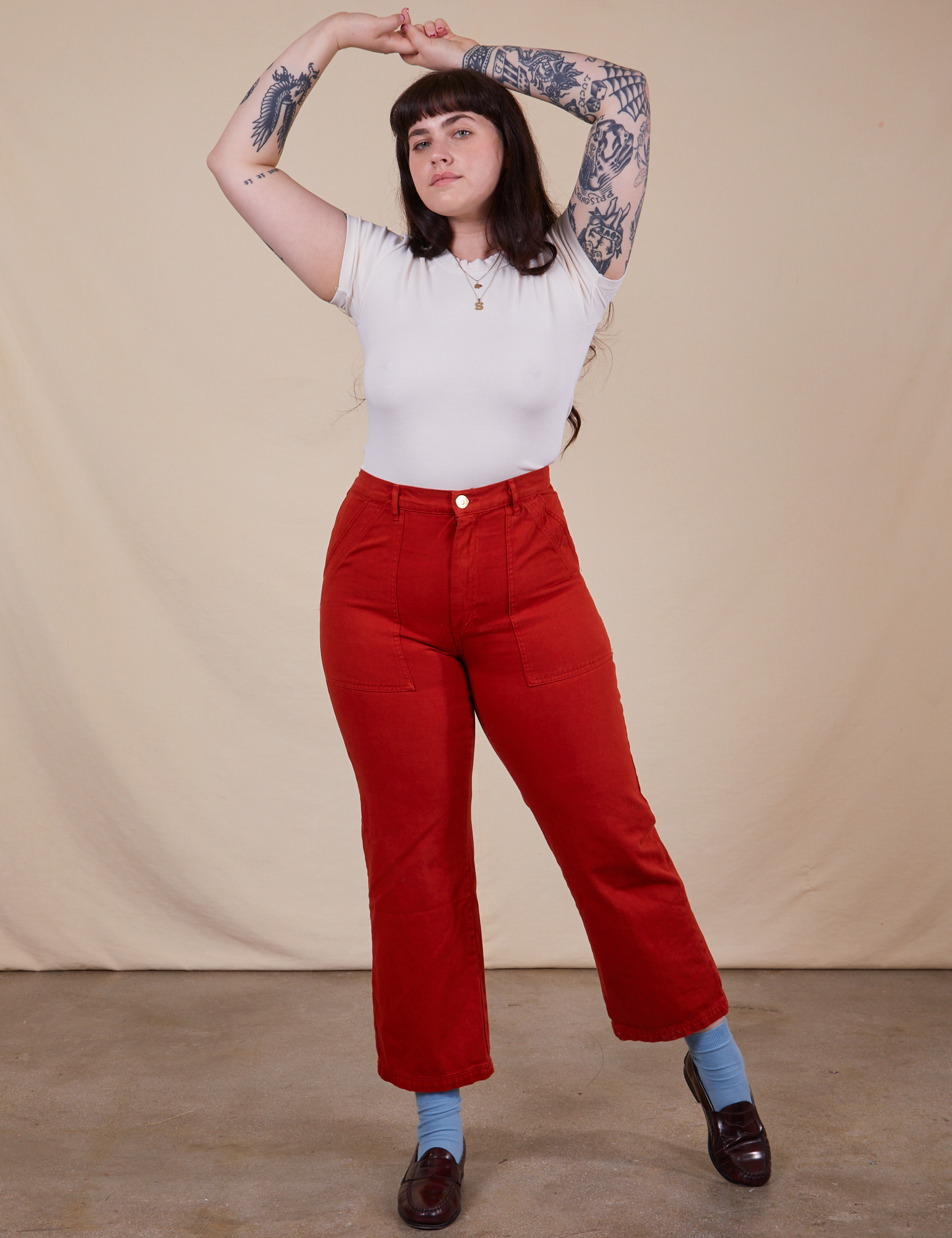 Sydney is 5&#39;9&quot; and wearing M Work Pants in Paprika paired with vintage off-white Baby Tee