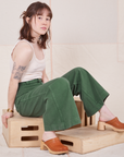 Hana is wearing Bell Bottoms in Dark Emerald Green and vintage off-white Tank Top