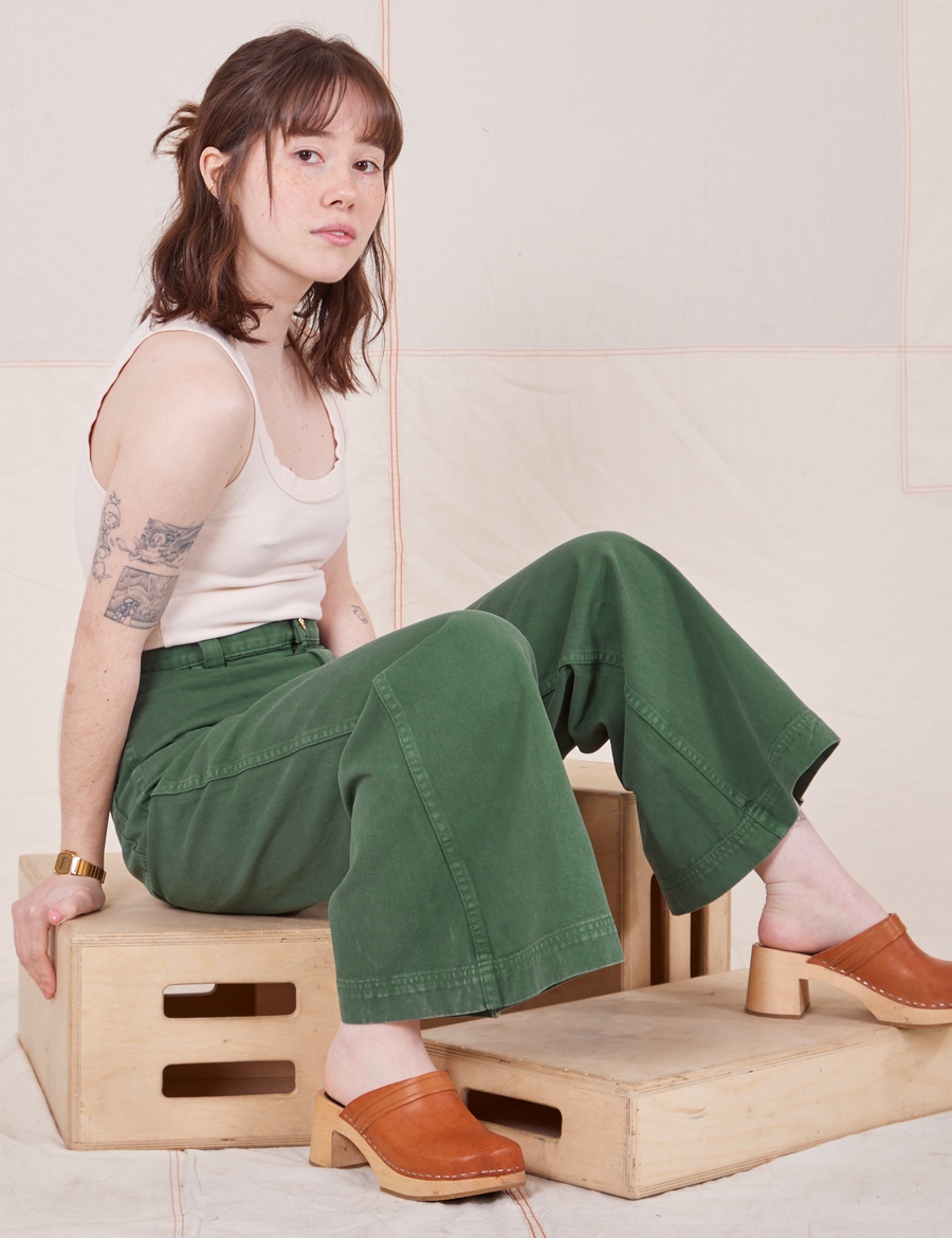 Hana is wearing Bell Bottoms in Dark Emerald Green and vintage off-white Tank Top