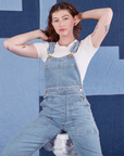 Indigo Denim Original Overalls in Light Wash on Alex wearing vintage off-white Baby Tee