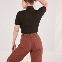 Back view on Allison wearing 1/2 Sleeve Essential Turtleneck in Espresso Brown and fudgesicle brown Bell Bottoms