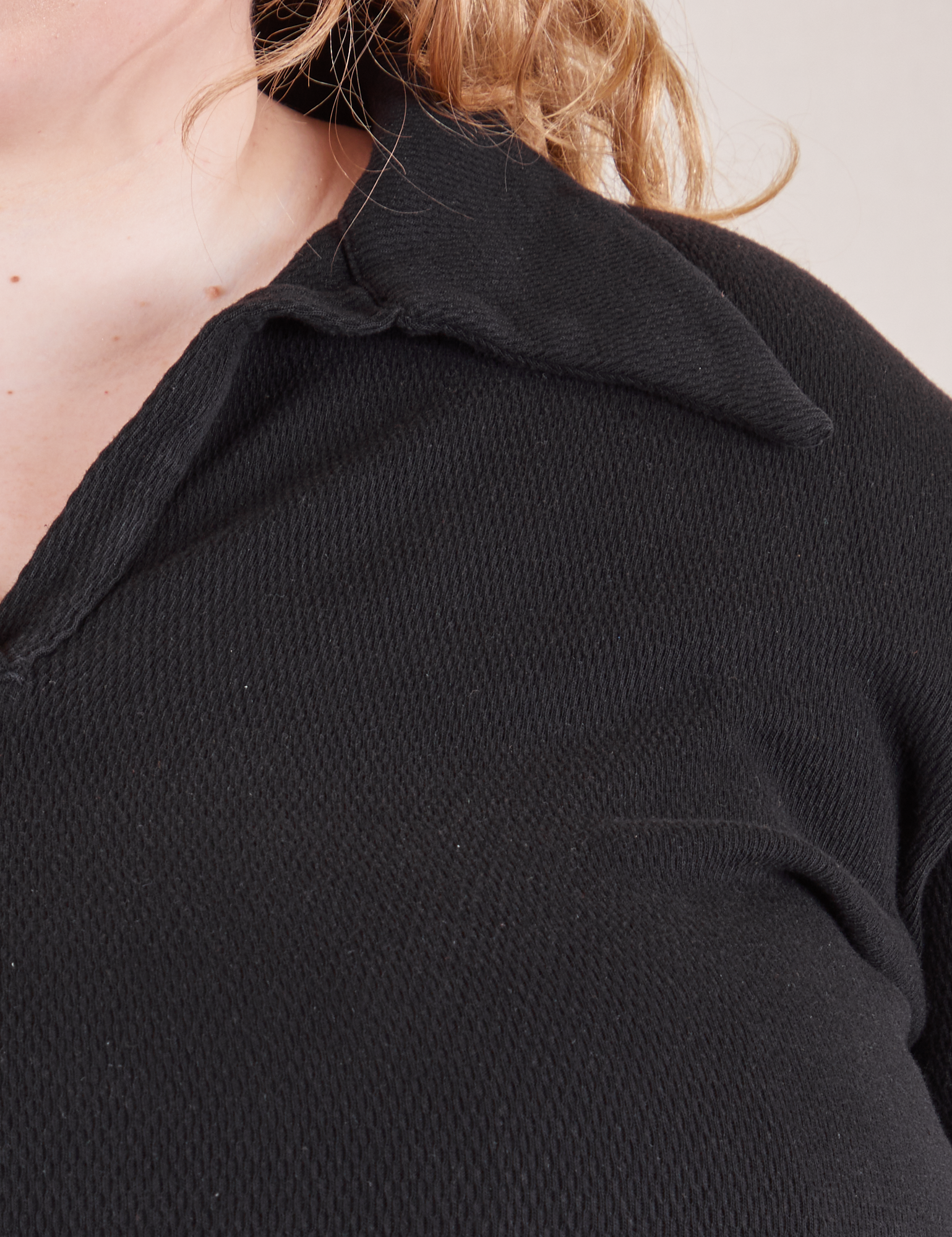 Front close up of Long Sleeve Fisherman Polo in Basic Black worn by Catie