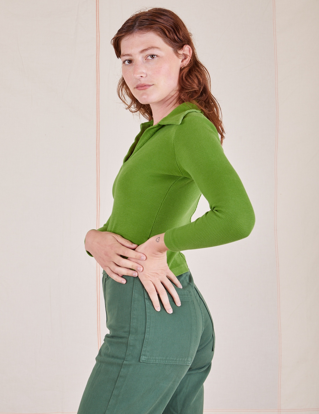 Long Sleeve Fisherman Polo in Bright Olive side view on Alex wearing dark emerald green Western Pants