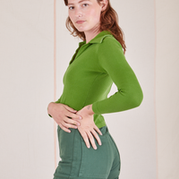 Long Sleeve Fisherman Polo in Bright Olive side view on Alex wearing dark emerald green Western Pants