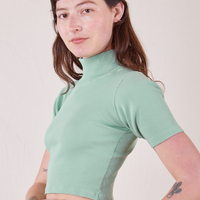 Side view of 1/2 Sleeve Essential Turtleneck in Sage Green on Alex