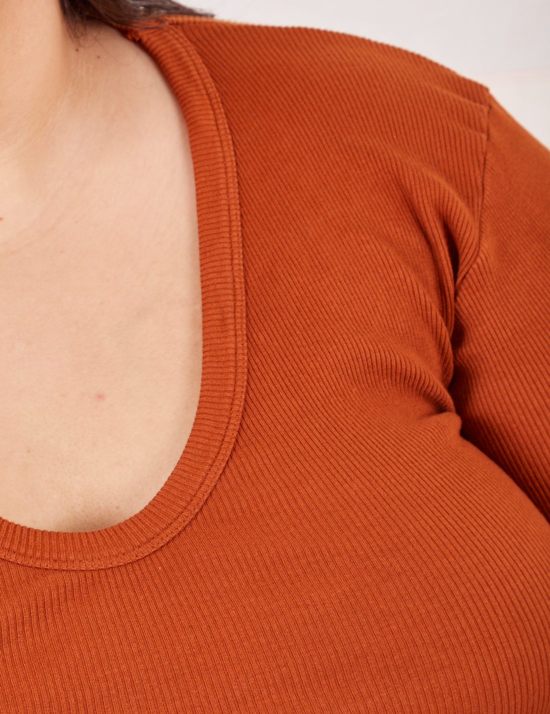 Long Sleeve V-Neck Tee in Burnt Terracotta neckline close up on Sarita