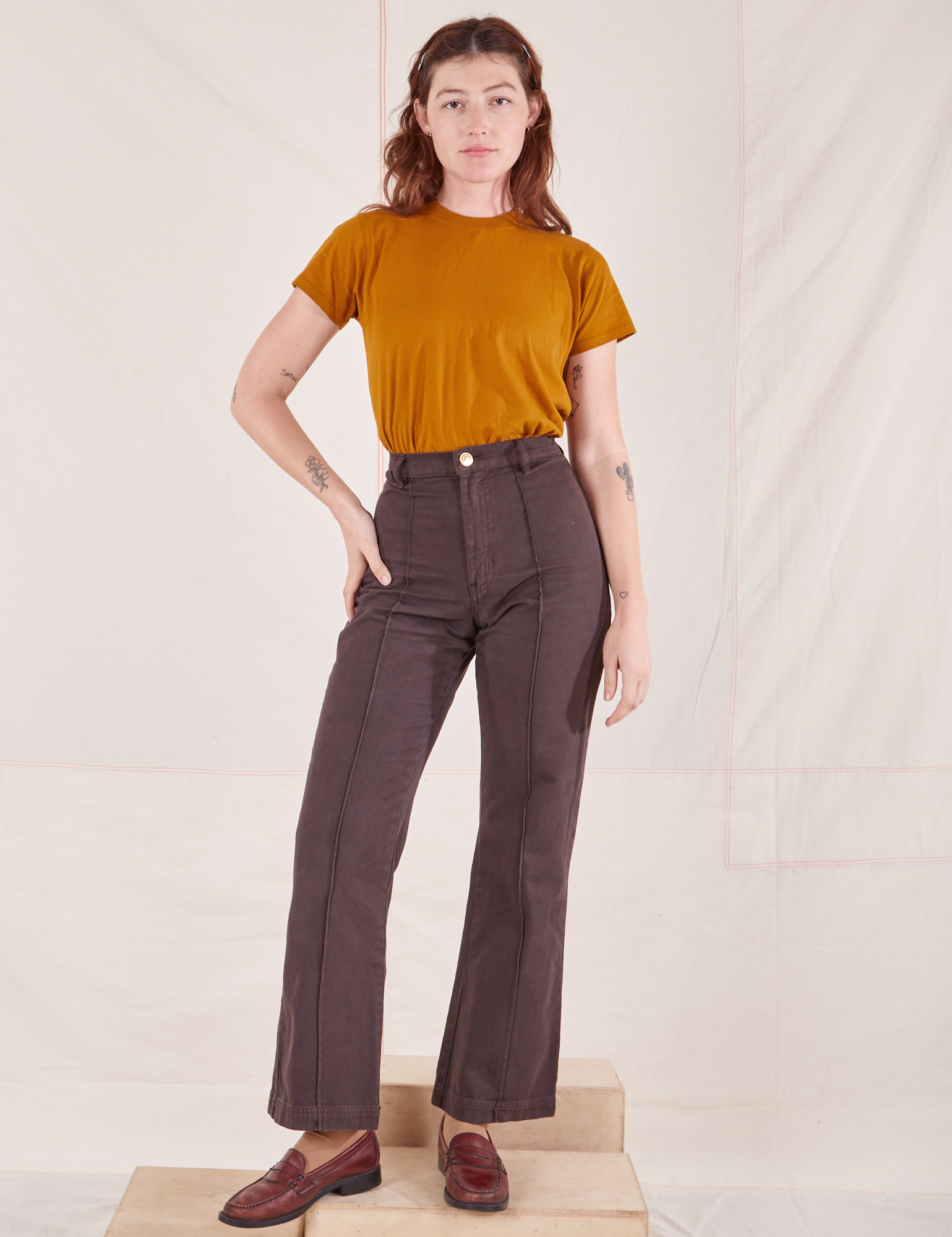 Alex is wearing P Organic Vintage Tee in Spicy Mustard paired with espresso brown Western Pants