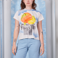 Alex wearing size P Peach Airbrush Organic Tee paired with baby blue Bell Bottoms
