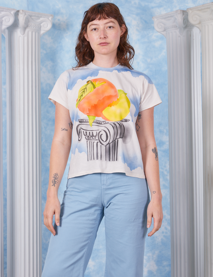 Alex wearing size P Peach Airbrush Organic Tee paired with baby blue Bell Bottoms