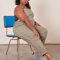 Side view of Original Overalls in Khaki Grey worn by Morgan sitting in a blue chair