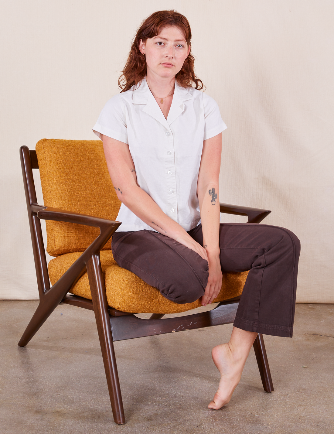 Alex is wearing Pantry Button-Up in Vintage Tee White and espresso brown Western Pants