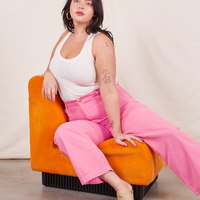Work Pants in Bubblegum Pink on Faye wearing vintage off-white Tank Top sitting in orange chair
