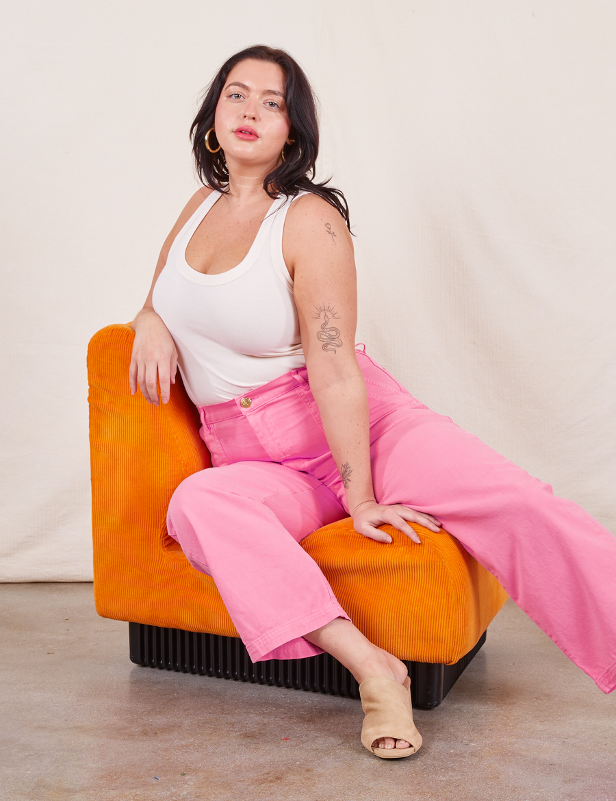 Work Pants in Bubblegum Pink on Faye wearing vintage off-white Tank Top sitting in orange chair