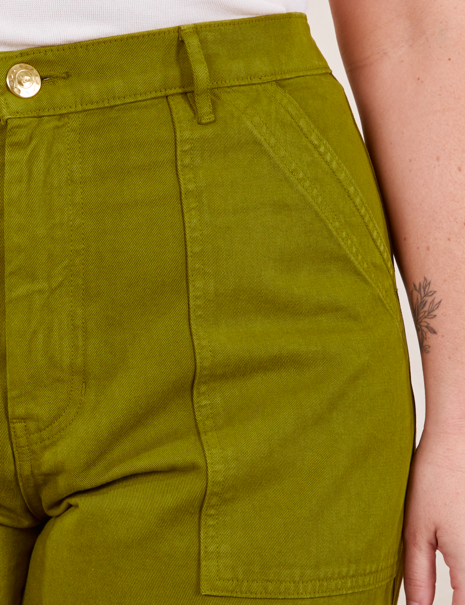 Work Pants in Olive Green front pocket close up on Faye