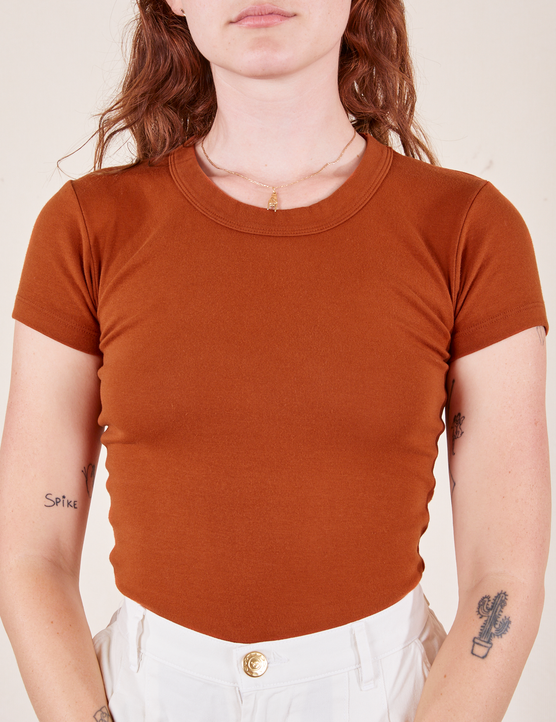 Alex is wearing Baby Tee in Burnt Terracotta