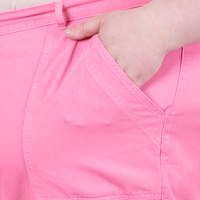 Work Pants in Bubblegum Pink front pocket close up. Worn by Catie with hand in pocket.
