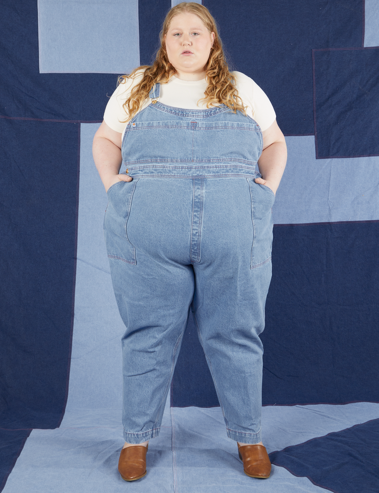 Catie is 5&#39;11&quot; and wearing 5XL Indigo Denim Original Overalls in Light Wash