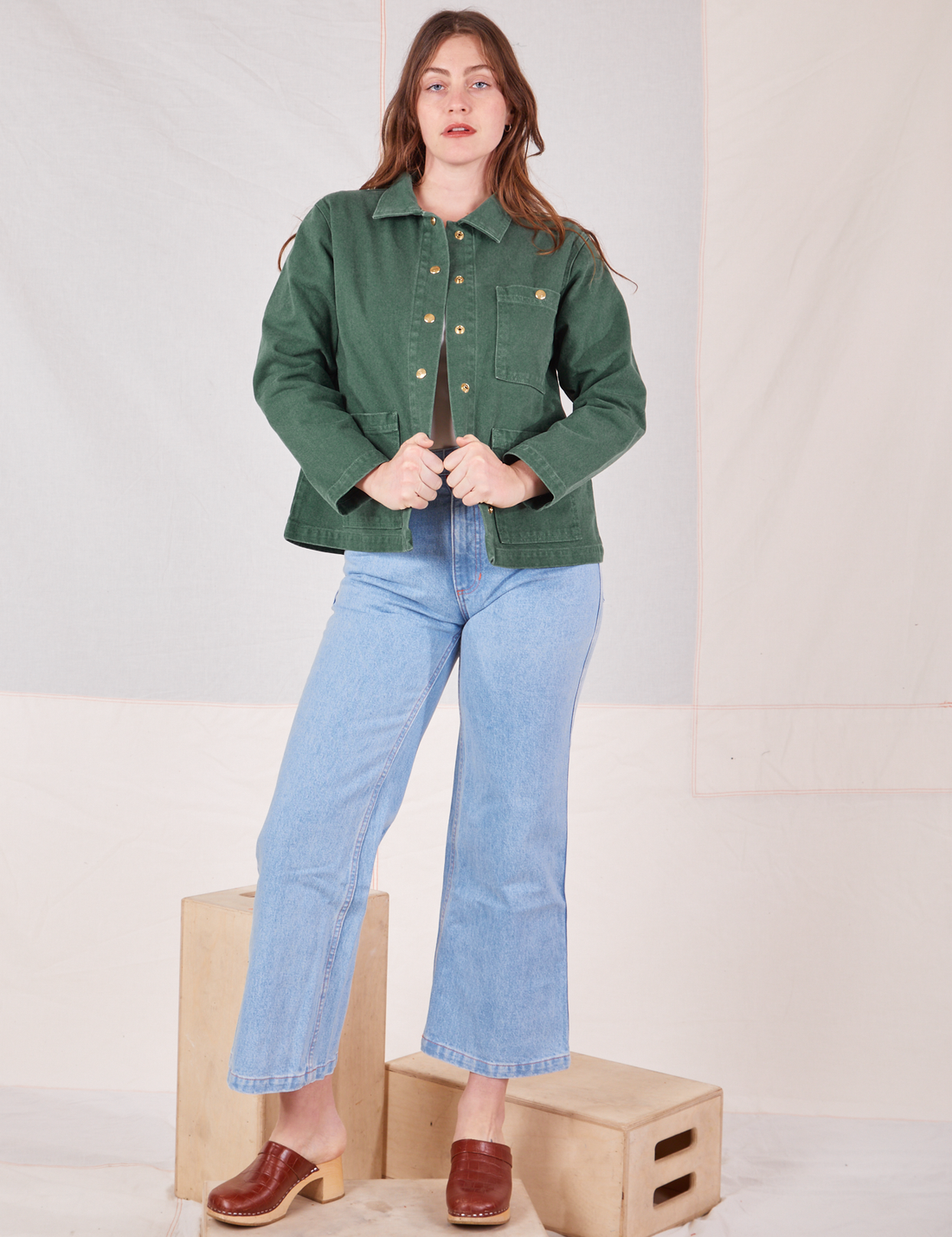 Allison is wearing Denim Work Jacket in Dark Green Emerald and light wash Sailor Jeans