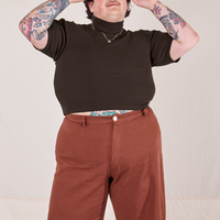 Sam is wearing size XL 1/2 Sleeve Essential Turtleneck in Espresso Brown paired with fudgesicle brown Bell Bottoms