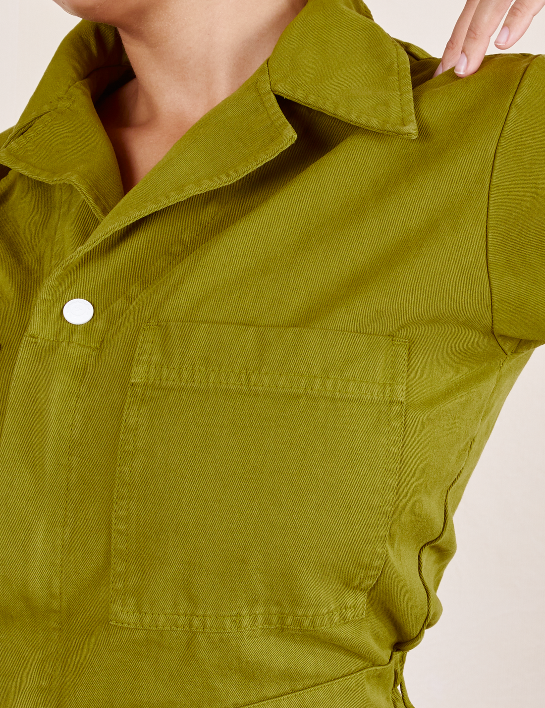 Short Sleeve Jumpsuit in Olive Green front pocket and collar close up on Tiara