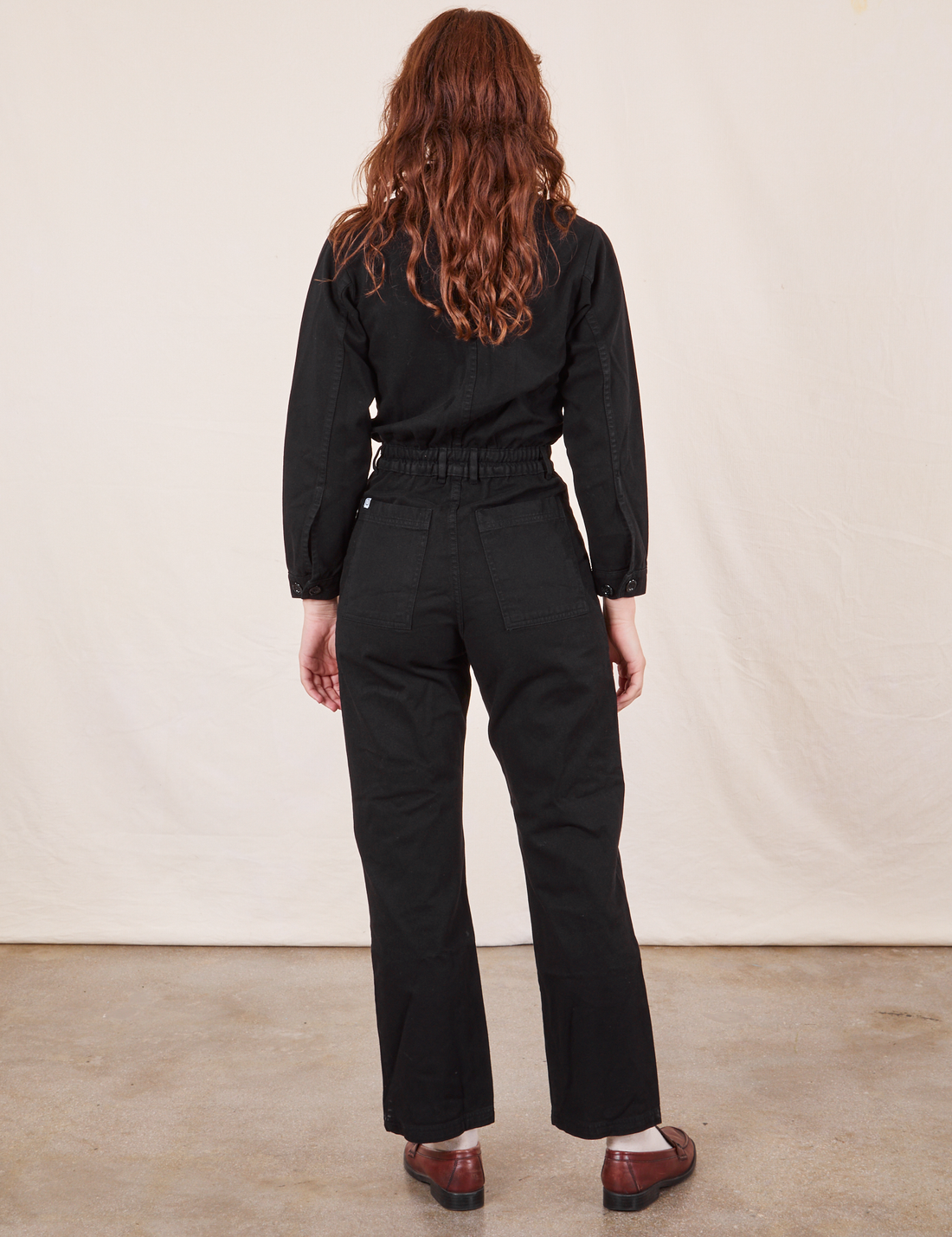 Back view of Everyday Jumpsuit in Basic Black worn by Alex