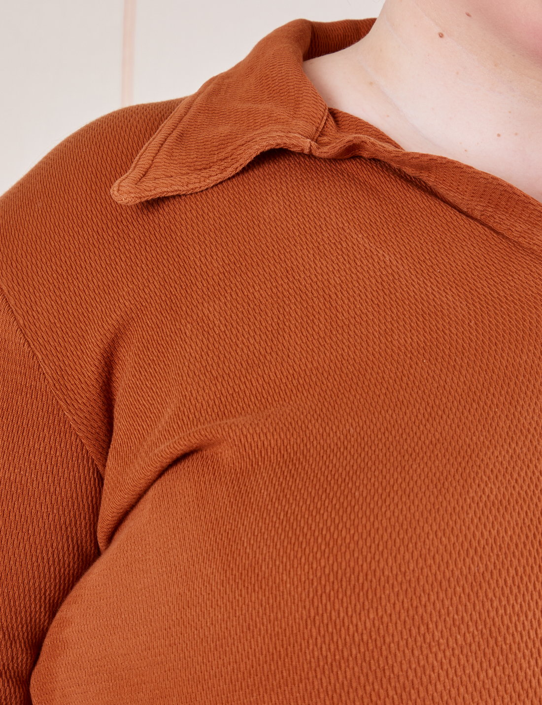 Front close up of Long Sleeve Fisherman Polo in Burnt Terracotta worn by Catie