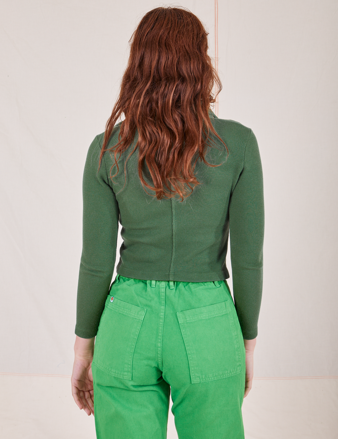 Back view of Long Sleeve Fisherman Polo in Dark Emerald Green worn by Alex
