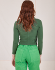 Back view of Long Sleeve Fisherman Polo in Dark Emerald Green worn by Alex