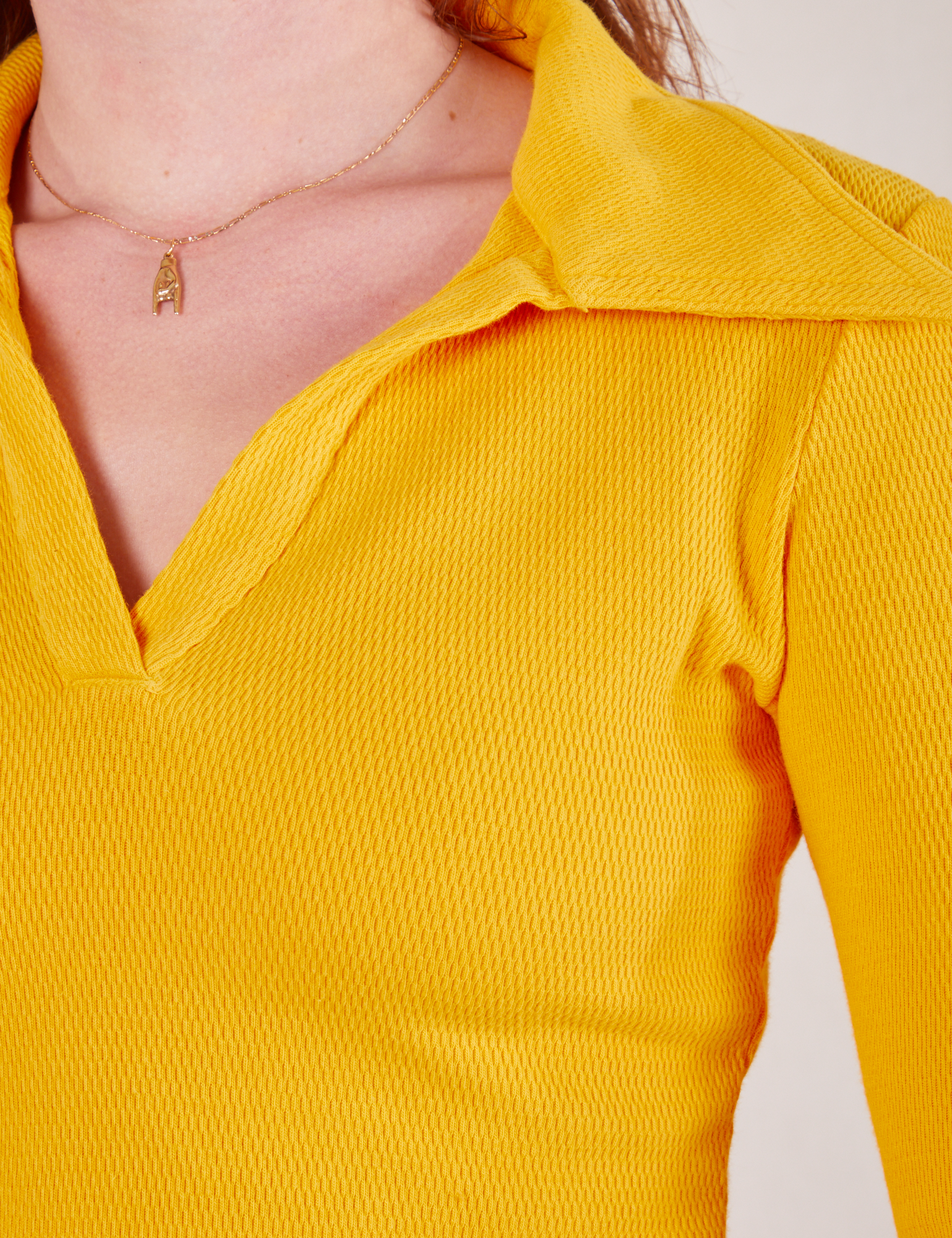 Front close up of Long Sleeve Fisherman Polo in Sunshine Yellow worn by Alex