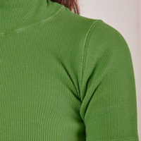 Front close up of 1/2 Sleeve Essential Turtleneck in Bright Olive worn by Alex