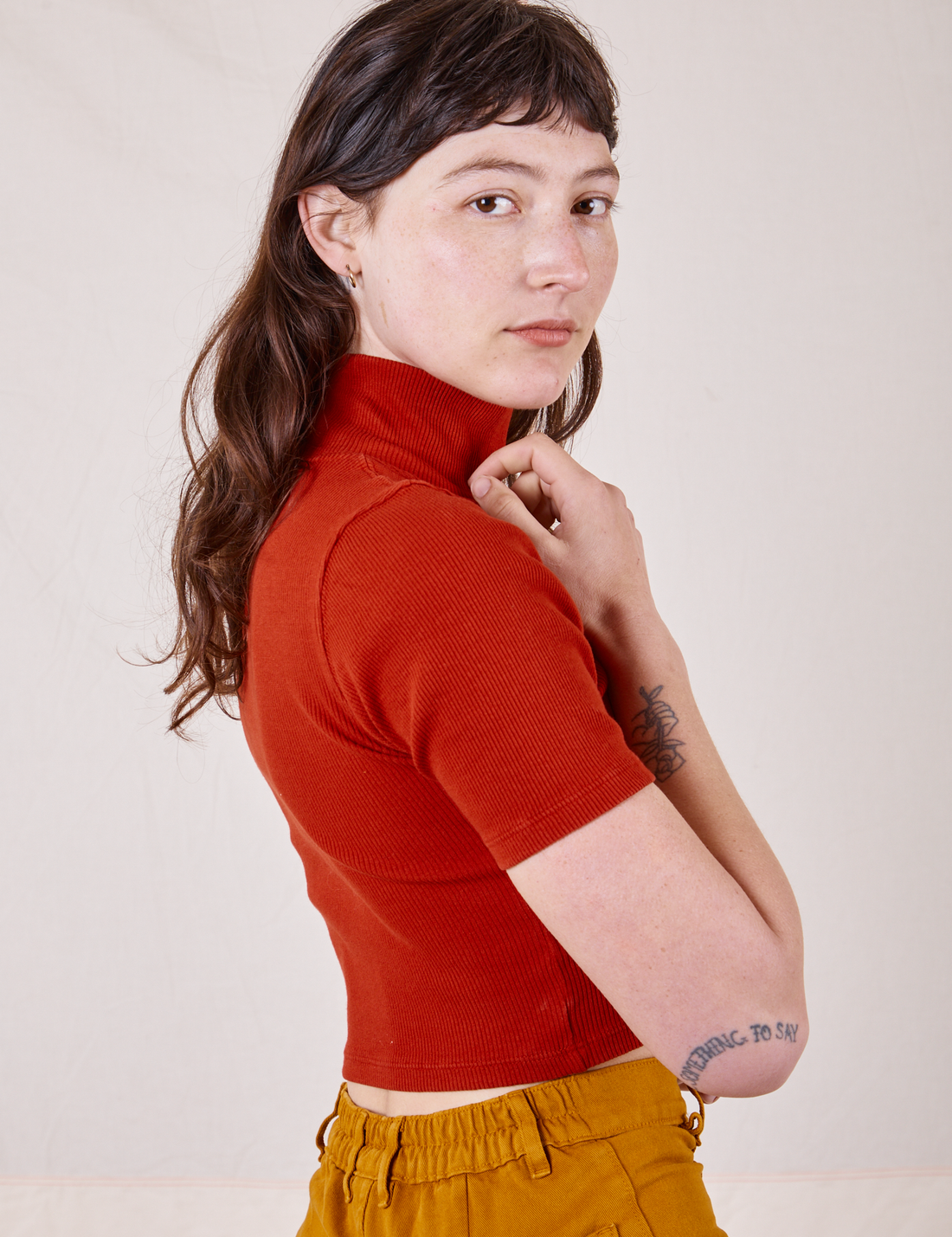 Side view of 1/2 Sleeve Essential Turtleneck in Paprika on Alex