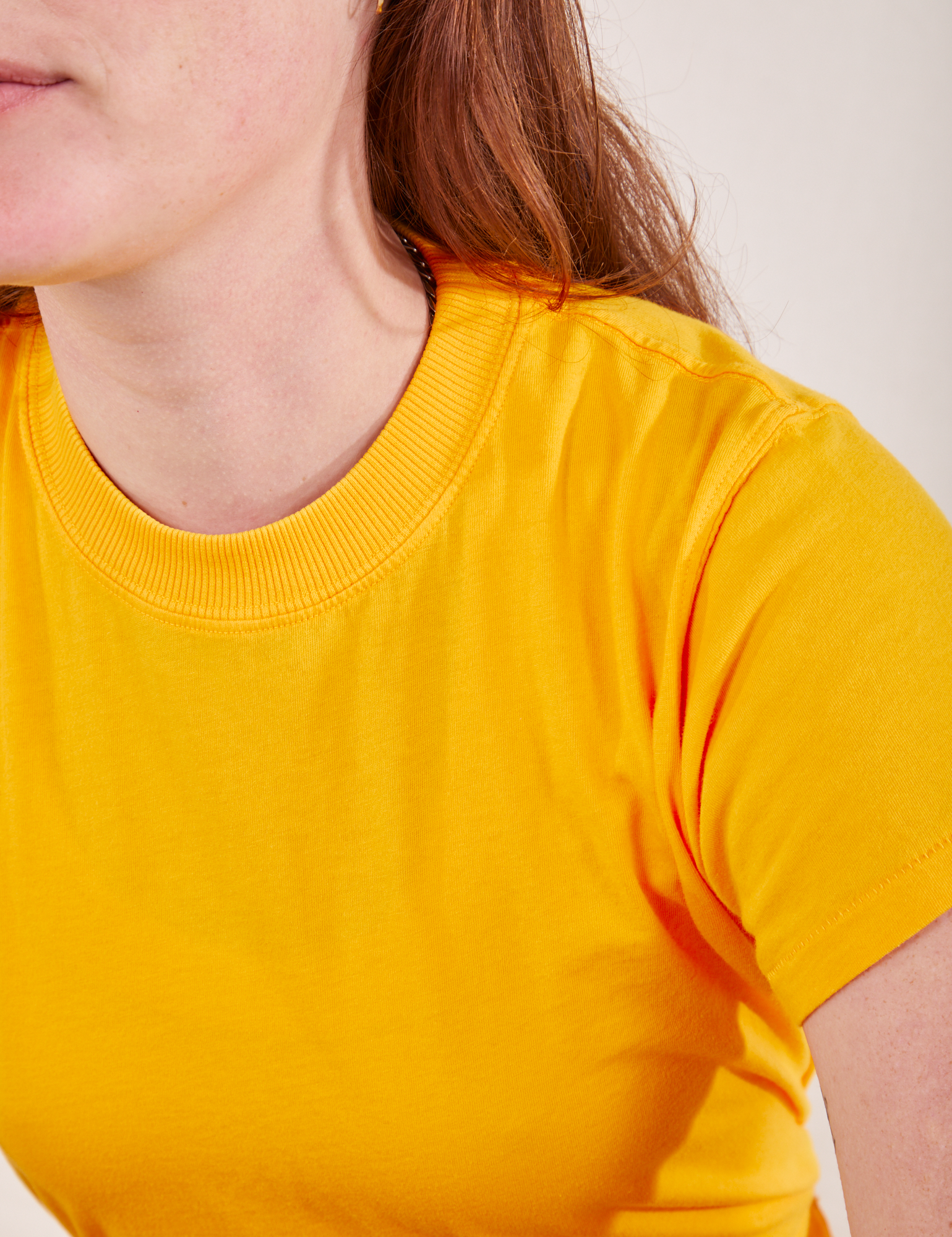 The Organic Vintage Tee in Sunshine Yellow front close up on Alex