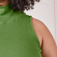 Front close up of Sleeveless Essential Turtleneck in Bright Olive worn by Lana