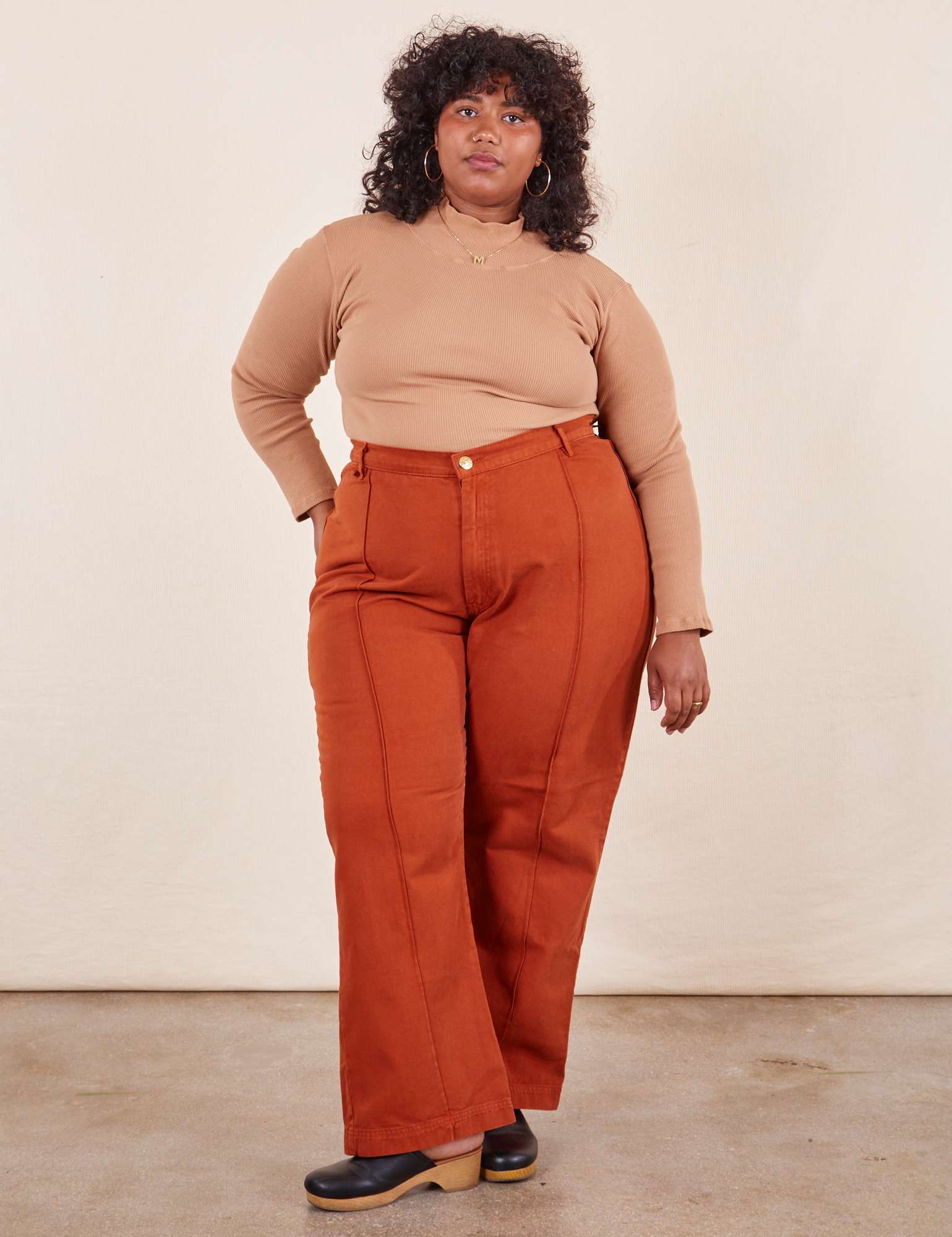 Morgan is 5&#39;5&quot; and wearing 1XL Western Pants in Burnt Terracotta and tan Essential Turtleneck