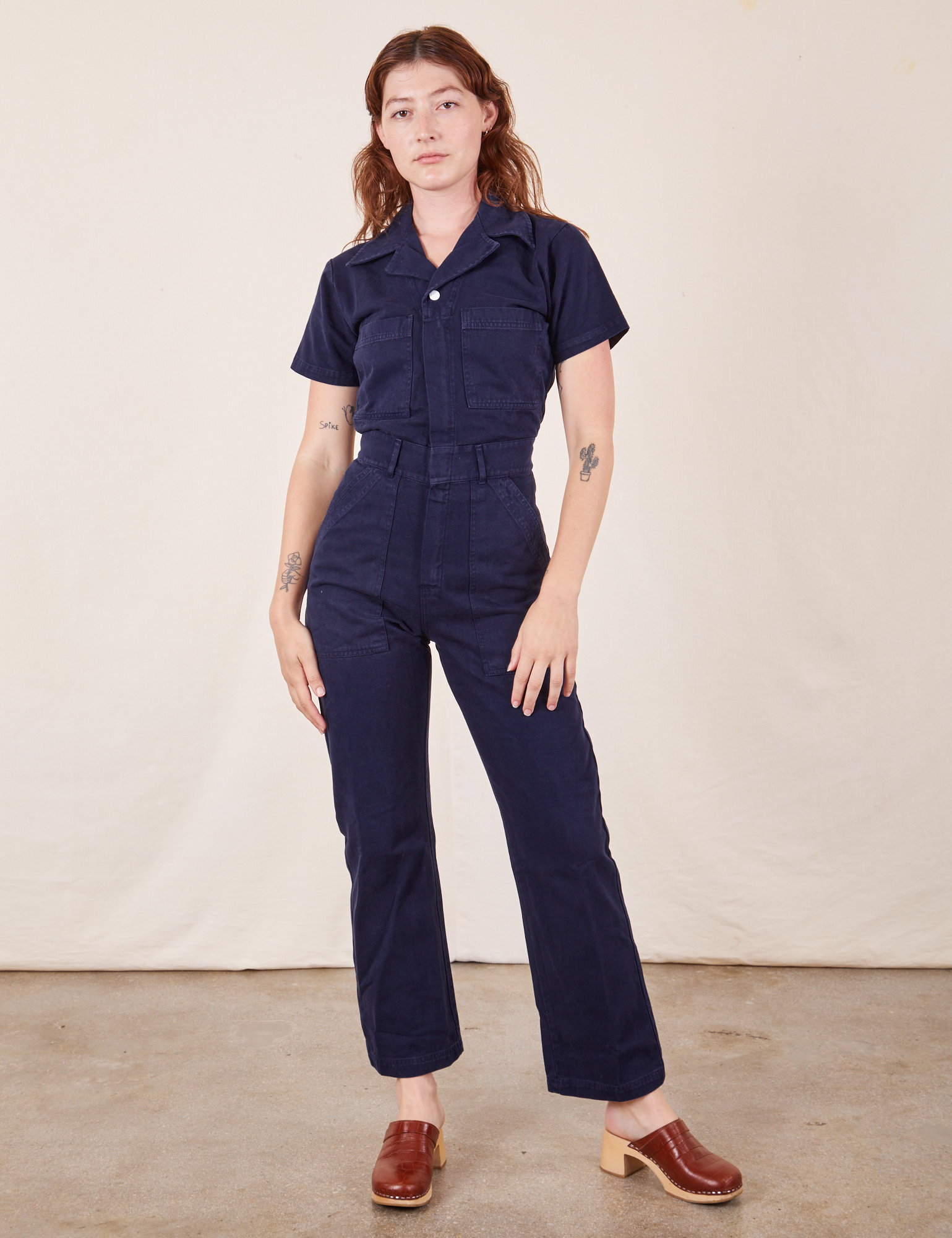 Alex is 5&#39;8&quot; and wearing XS Short Sleeve Jumpsuit in Navy Blue