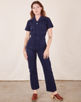 Alex is 5'8" and wearing XS Short Sleeve Jumpsuit in Navy Blue