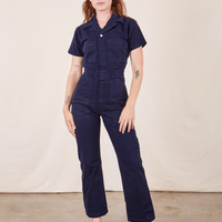 Alex is 5'8" and wearing XS Short Sleeve Jumpsuit in Navy Blue