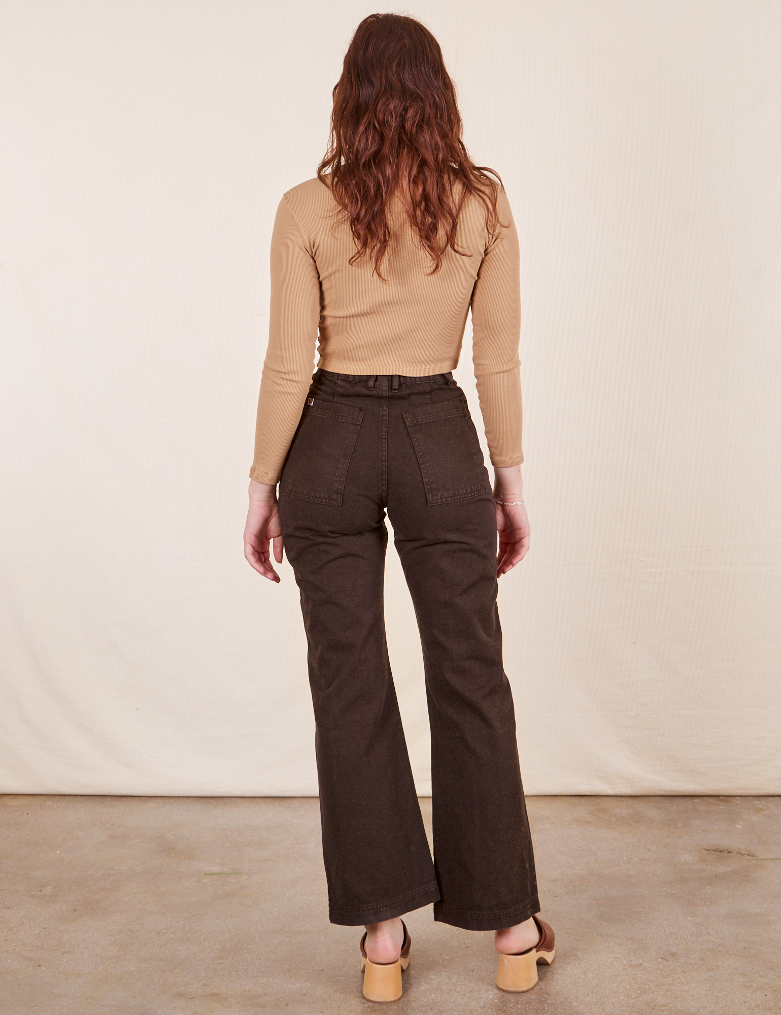 Back view of Western Pants in Espresso Brown paired with tan Essential Turtleneck worn by Alex