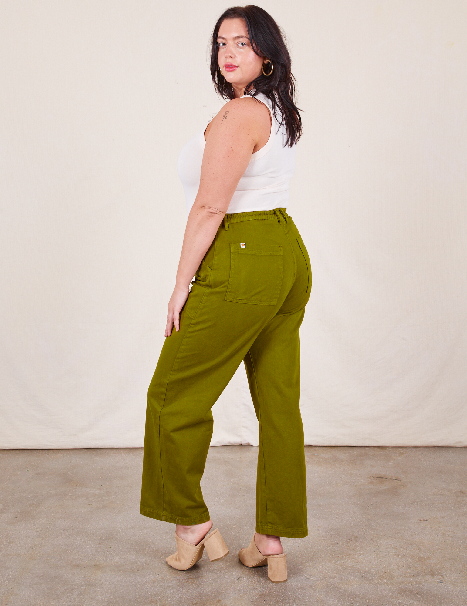 Angled back view of Work Pants in Olive Green on Faye