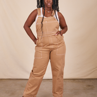 Shai is 5'5" and wearing M Original Overalls in Tan