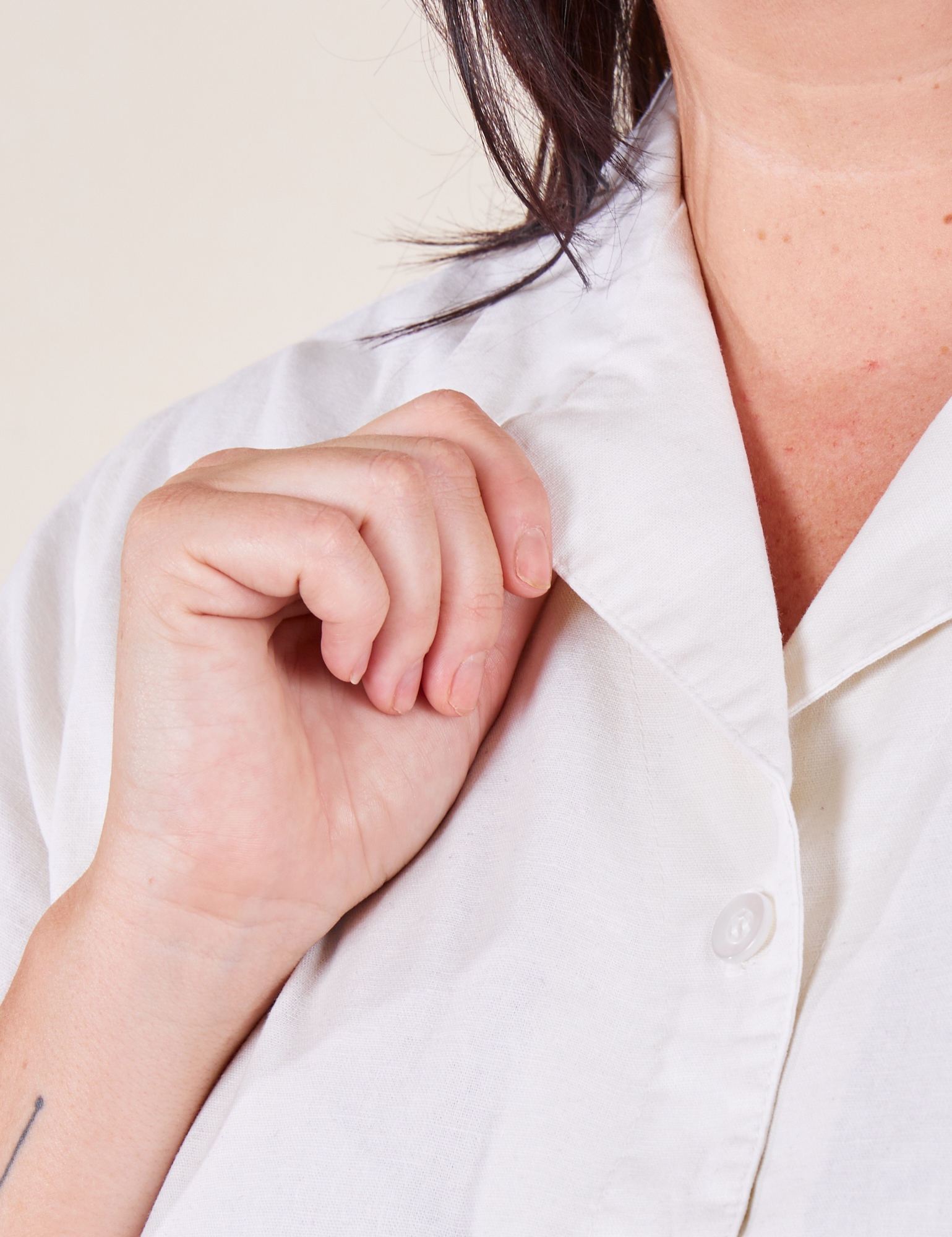 Pantry Button-Up in Vintage Tee White close up on Faye holding collar