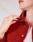Collar close up of Denim Work Jacket in Paprika. Allison is holding onto the collar.